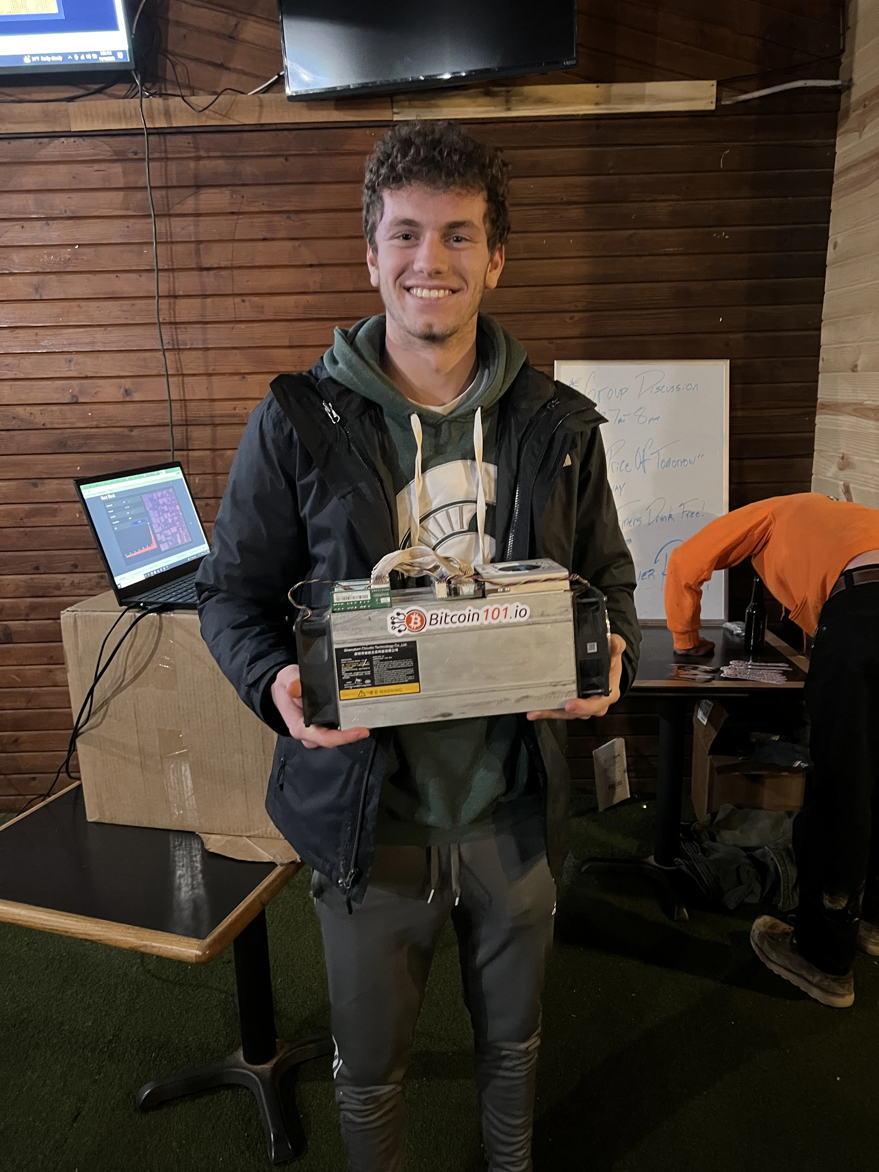 Picture of me holidng a s9 bitcoin miner in a michigan state sweatshirt
